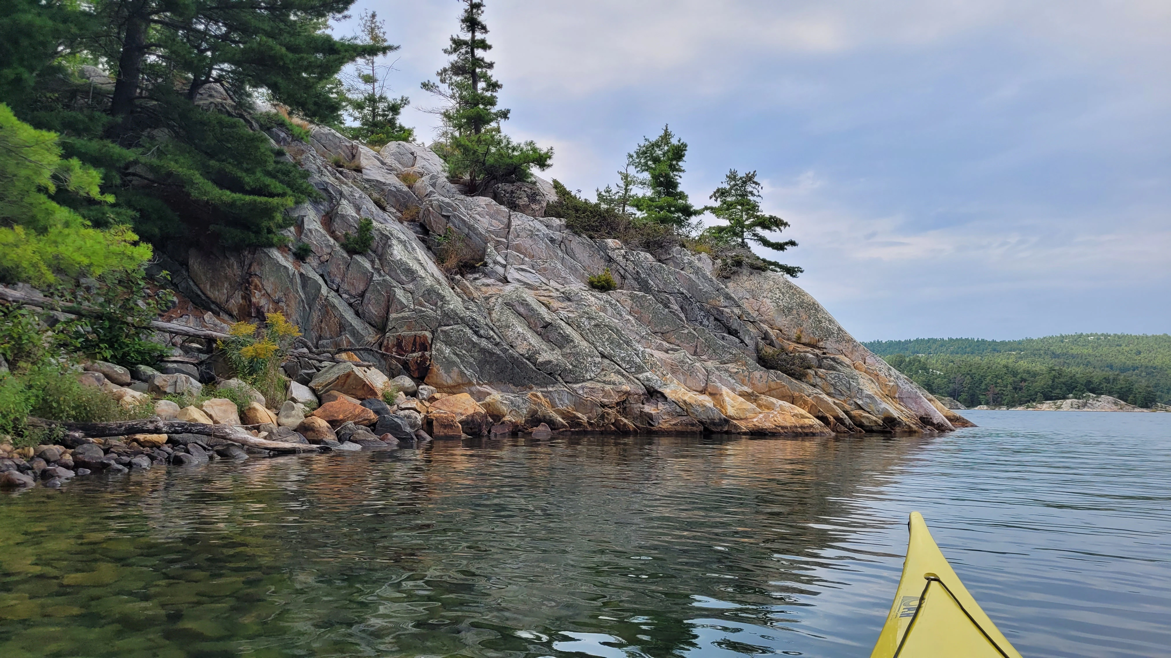 White quartzite cliffs and windswept pine trees in Killarney Bay Ontario Canada